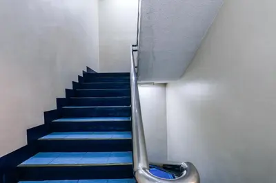 a staircase with blue tiles and a metal hand rail at Paragon Tower Hotel in Manila