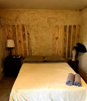 a bedroom with a bed with two towels on it at Marius B&B & Hostel in Silang