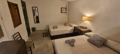a small room with two beds and a couch at Marius B&B & Hostel in Silang