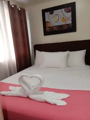 a heart made out of towels on a bed at RLR Condo at Shell Residences in Manila