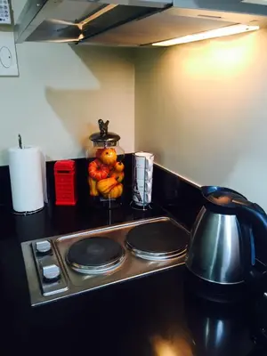 a kitchen with a stove top with a tea kettle at RLR Condo at Shell Residences in Manila