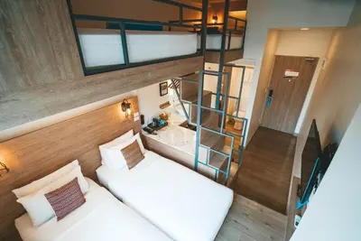 a bedroom with a bunk bed and a ladder at Lub d Manila Makati - Central Makati, Near Nightlife in Manila