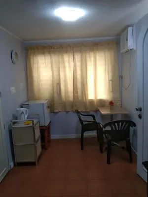 a kitchen with a table and chairs and a window at The Terrace Room in Manila