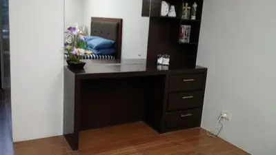 a desk in the corner of a room at Burgundy McKinley Place in Manila
