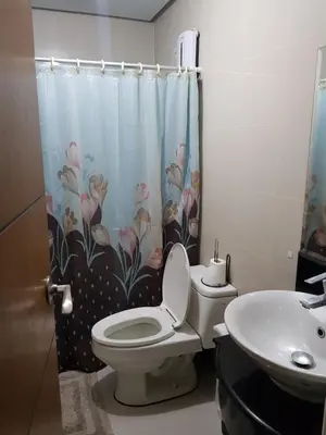a bathroom with a toilet and a sink at Morgan Suites in Manila