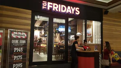 a woman standing at a counter in a restaurant at Morgan Suites in Manila