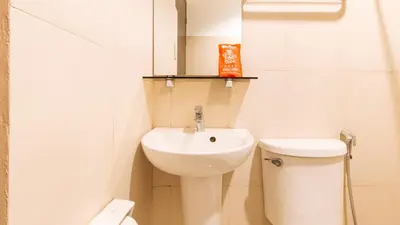 a small bathroom with a sink and a toilet at RedDoorz at San Antonio Makati in Manila