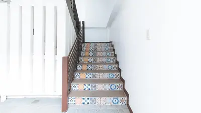 a staircase with blue and white plates on it at RedDoorz at San Antonio Makati in Manila