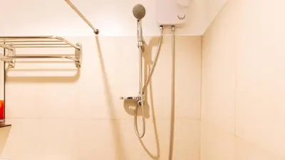 a shower with a shower head in a bathroom at RedDoorz at San Antonio Makati in Manila