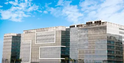 a building with a sign on the top of it at Savoy Hotel Manila near Airport NAIA Terminal 3 MNL in Manila
