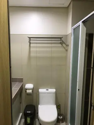 a small bathroom with a toilet and a sink at Manila Bay Breeze Residences with Pool View in Manila