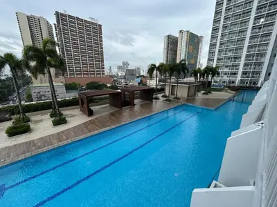 a large swimming pool on the roof of a building at Manila Bay Breeze Residences with Pool View in Manila