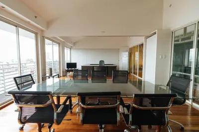 a dining room with a glass table and chairs at RedDoorz near Osmena Highway 1 in Manila