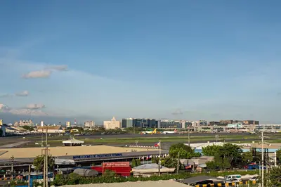 a view of an airport with a city in the background at Achievers Airport Hotel in Manila