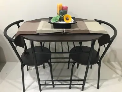 a small black table with a plate of food on it at One Palm Tree Apartments in Manila