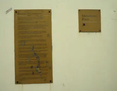 a sign on a wall that says swimming point at Suites de Marina Manila with Netflix in Manila