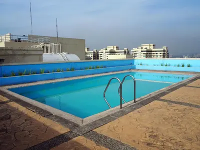 a swimming pool on the roof of a building at Suites de Marina Manila with Netflix in Manila