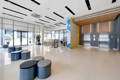 an empty lobby with stools in a building at Hop Inn Hotel Aseana City Manila in Manila