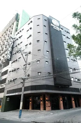a building with a clock on the side of it at U Hotels Makati in Manila