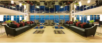 a large room with couches and tables and windows at Your HOME @ Princeton Residences, New Manila in Manila