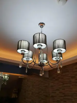 a chandelier hanging from a ceiling in a room at Your HOME @ Princeton Residences, New Manila in Manila