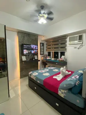 a bedroom with a bed with a teddy bear on it at Your HOME @ Princeton Residences, New Manila in Manila