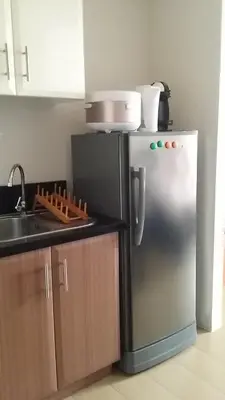a kitchen with a stainless steel refrigerator and a sink at 150 Newport City Condo - near NAIA T3 AIRPORT MANILA in Manila