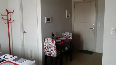a room with a table and a chair in a room at 150 Newport City Condo - near NAIA T3 AIRPORT MANILA in Manila