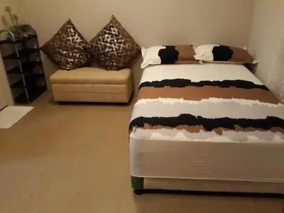 a bedroom with a bed and a couch at 150 Newport City Condo - near NAIA T3 AIRPORT MANILA in Manila