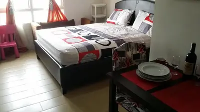 a bedroom with a bed and a table with plates on it at 150 Newport City Condo - near NAIA T3 AIRPORT MANILA in Manila