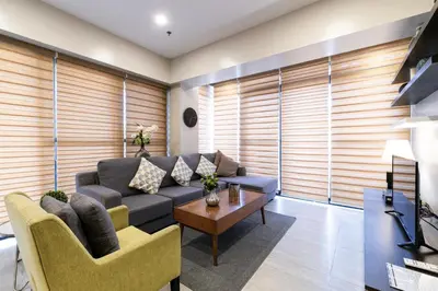 a living room with a couch and a table at Artemis Place Makati Hotel in Manila