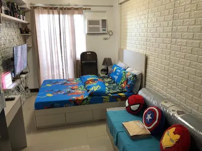a small bedroom with a bed and a couch at Pine Crest Condominium in Manila