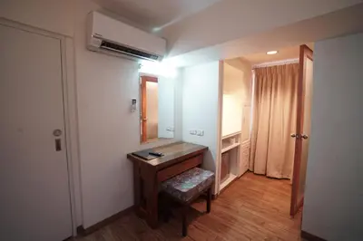 a bathroom with a wooden desk and a mirror at 1775 Adriatico Suites in Manila