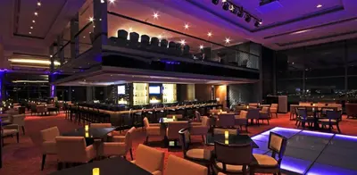 a restaurant with tables and chairs and a bar at The Bellevue Manila in Manila