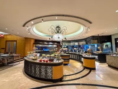 a restaurant with a buffet line with food on display at The Bellevue Manila in Manila