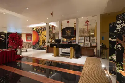 a lobby of a restaurant with a grand piano at The Bellevue Manila in Manila