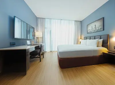 a hotel room with a bed and a desk with a computer at The B Hotel Alabang in Manila
