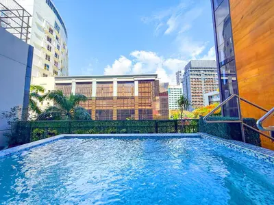 a swimming pool in the middle of a city at The B Hotel Alabang in Manila