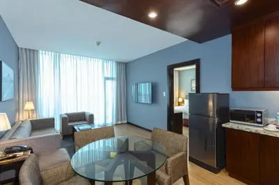 a living room with a couch and a table at The B Hotel Alabang in Manila