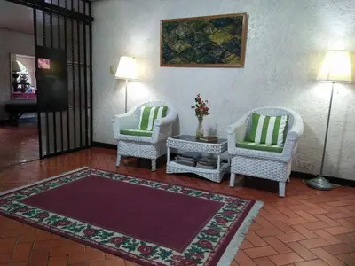 a living room with two chairs and a rug at Casa Joaquin BnB in Manila