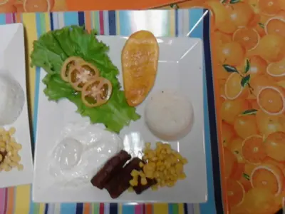 a white plate with food on a table at Casa Joaquin BnB in Manila