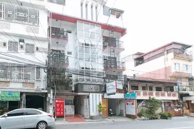 a car parked in front of a tall building at RedDoorz at DBuilders Rooms Ph1 Taguig in Manila