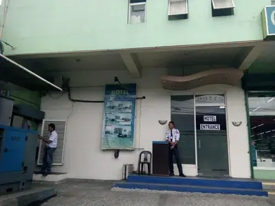 two men are standing outside of a building at Asia Novo Boutique Hotel - Rosario in Rosario