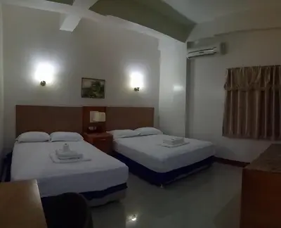 a hotel room with two beds and a window at Asia Novo Boutique Hotel - Rosario in Rosario