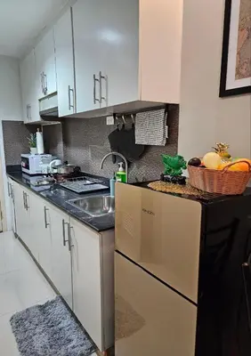 a kitchen with a sink and a counter top at Reese @ Sea Residences Manila in Manila