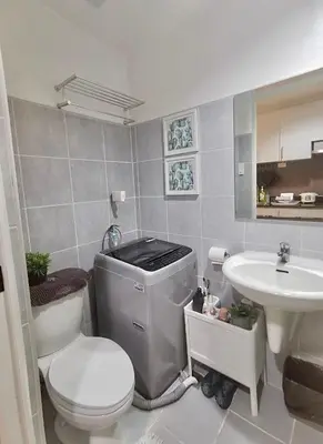 a bathroom with a toilet and a sink at Reese @ Sea Residences Manila in Manila