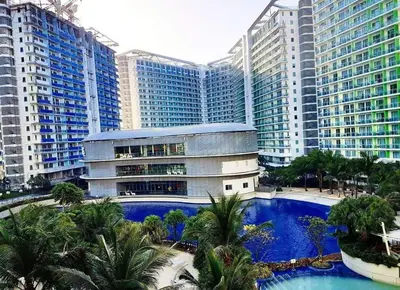 a building with a swimming pool in front of tall buildings at Azure C7 Balcony, Wifi, Near Mall Airport in Manila