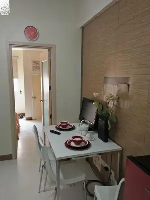 a table with plates on it in a kitchen at CHATEAU ELYSSE a4 near SM Mall,AIRPORT Wifi in Manila