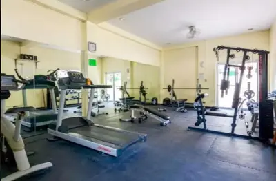 a gym with several treadmills and exercise machines at CHATEAU ELYSSE a4 near SM Mall,AIRPORT Wifi in Manila