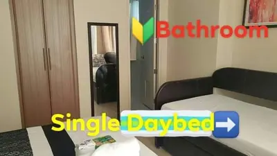 a small bedroom with a bed and a mirror at Condo Apartment near Manila Airport NAIA T3 in Manila